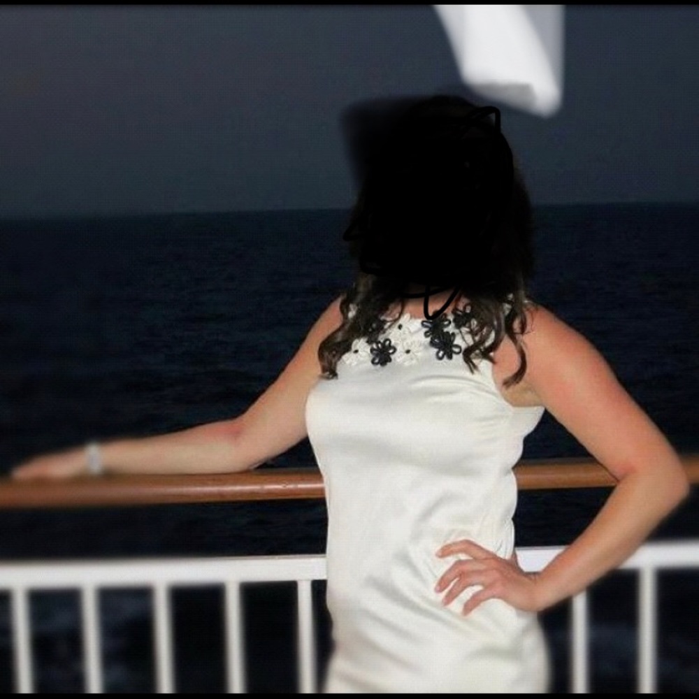 white dress with black and white flowers around neckline